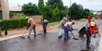 Slurry sealing of road using labour intensive methods in Block H, Soshanguve